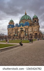 BERLIN, GERMANY - MARCH 2019: The Berlin cathedral (Berliner Dom) on the museum island in central Berlin as seen from the Lustgarten park on the west side of the church against a cloudy sky