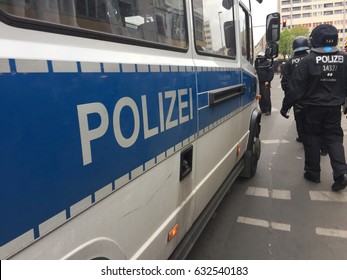 Berlin, Germany - May 1, 2017: German National Police White And Blue Truck And Back Turned Policeman