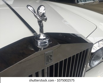 Berlin, Germany - May 13, 2017: Rolls Royce Hood Ornament On A White Vintage Car. Founded In 1906, It Is A British Car-manufacturing And Aero-engine Manufacturing Company