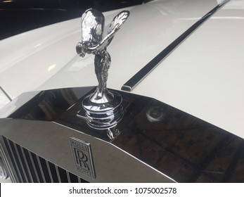 Berlin, Germany - May 13, 2017: Rolls Royce Hood Ornament On A White Vintage Car. Founded In 1906, It Is A British Car-manufacturing And Aero-engine Manufacturing Company