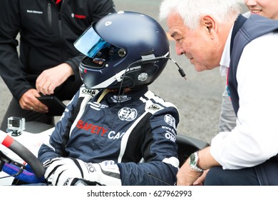 Berlin, Germany - May 20, 2016: Unrecognizable Pilot Of FIA Formula E Racing Car Championship With Full Helmet. FIA Championship Is A Class Of Auto Racing Using Only Fully Electric-powered Cars