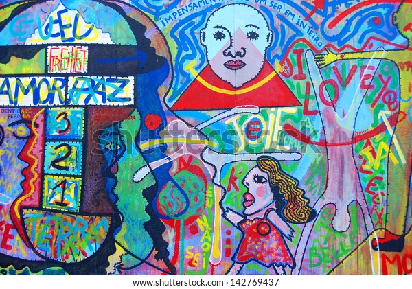 BERLIN GERMANY MAY 22: Mural Kim Prisu
metamorphose des existences lie par un mobile indÃ?Â©fini  on may
22 2010 in Berlin Germany. East Side Gallery - the largest outdoor
art gallery in the
world.