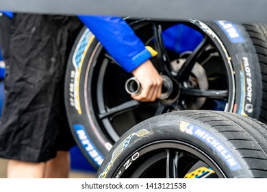Berlin, Germany - May 25, 2019: Mechanic checking the Michelin tyres for race cars participating in the ABB FIA Formula E street racing Championship - Shutterstock ID 1413121538