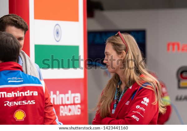 Berlin, Germany - May 25,\
2019: Young woman staff member of the Mahindra Racing, motorsport\
team owned by Mahindra & Mahindra, an Indian automobile\
manufacturer