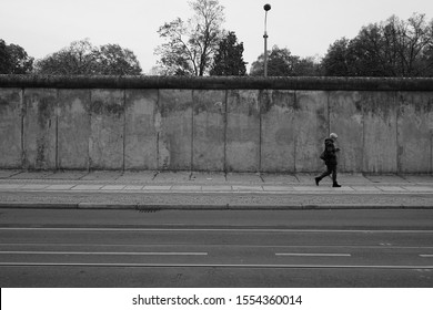 Berlin, Germany - November 1 2019: A woman is walking in front of Berlin Wall