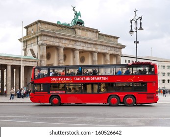 BERLIN, GERMANY - OCTOBER 17: tourist double decker bus near Brandenburg gate in Berlin on October 17, 2013. The bus city tour takes about 2 hours with live commentary via headÃ?Â?Ã?Â­phones in 9 languages