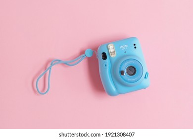 BERLIN, GERMANY- OCTOBER 30, 2020: The blue turquoise Fujifilm Instax mini 11 instant camera on background.