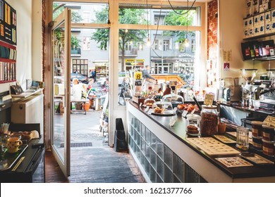 Berlin / Germany - September 2018: A Cafe With An Outdoor Patio Has Its Doors Open To A Busy Street In Neukolln, A Popular Neighborhood In Berlin.