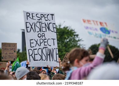 Berlin, Germany - September 24th, 2021: A Young Person Holding Up A Sign To Protest Against Climate Change Policies In Berlin In Front Of The Reichstag Building