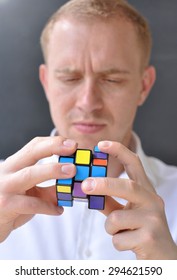 BERLIN - JUL 05:  A Man Trying To Solve A Rubiks Cube In Berlin On July 05. 2015 In Germany This Famous Cube Puzzle Was Invented By The Architect Erno Rubik In 1974