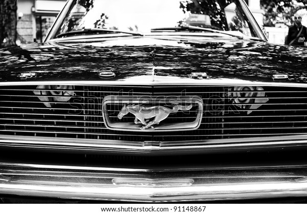BERLIN\
- MAY 28: Radiator (engine cooling) and the emblem of the car Ford\
Mustang, the exhibition \
