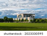 Berlin Mitte, office of the Federal Chancellor of Germany, Bundeskanzleramt. German chancellery, more faithfully translated as Federal Chancellery. Panoramic view with meadow. Sunny with dramatic sky.