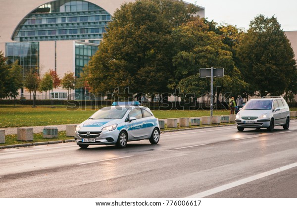 Berlin, October 2,\
2017: A police car is moving along the street. Protection and\
safety of people by the police. Patrolling the streets for law and\
order purposes.