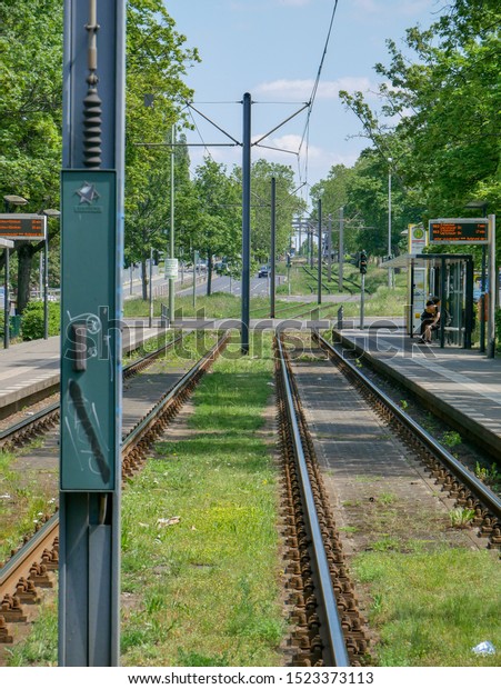 BERLIN, PANKOW / GERMANY - JUNE 2\
2019: Green rail tracks for the tram on a  avenue in\
Berlin.