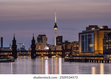 Berlin with the river Spree at dusk with the Oberbaum Bridge and the famous Television Tower