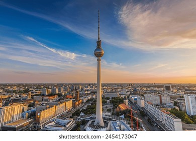 Berlin TV tower at sunset. Skyline of the capital of Germany. City center around Alexanderplatz with buildings and streets in the evening. Red Town Hall of Berlin in the background - Powered by Shutterstock