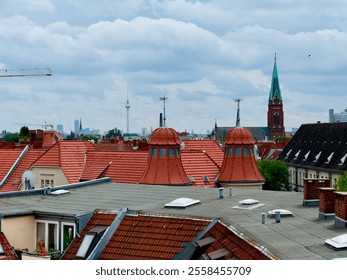 Berlin Wedding Rooftop view of a cityscape featuring red-tiled roofs, historical architecture, and landmarks, including the Berlin TV Tower (Fernsehturm) and a church steeple under a cloudy sky - Powered by Shutterstock