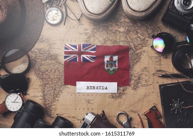 Bermuda Flag Between Traveler's Accessories on Old Vintage Map. Overhead Shot