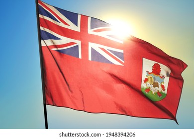 Bermuda flag waving on the wind in front of sun