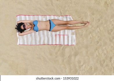 Bermuda Sunbathing, Beautiful Brunette Girl Is Sunbathing On An Empty Beach, Aerial View From Top.