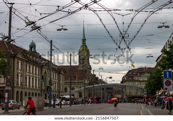 BERN, SWITZERLAND - Jun 21, 2012: The view of the tram\
station on the Bahnhofplatz, with the Heiliggeistkirche  Bern,\
Switzerland 
