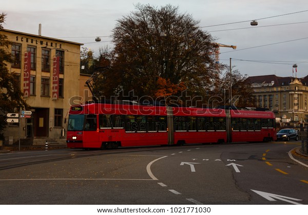 Bern,\
Switzerland - October 29, 2017: Street view with red tram in the\
old town of Bern city. Bern,\
Switzerland