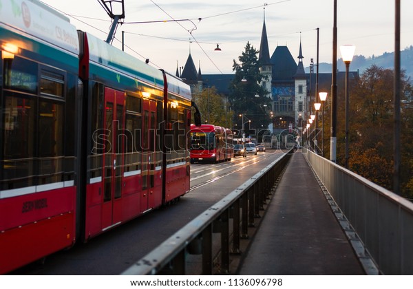 Bern,\
Switzerland - October 29, 2017: Street view with red tram in the\
old town of Bern city. Bern,\
Switzerland