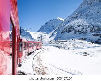 Bernina, Switzerland: trains of the Rhaetian Railway in transit along the line Tirano - St.Moritz during a beautifun sunny day. - Shutterstock ID 605487104