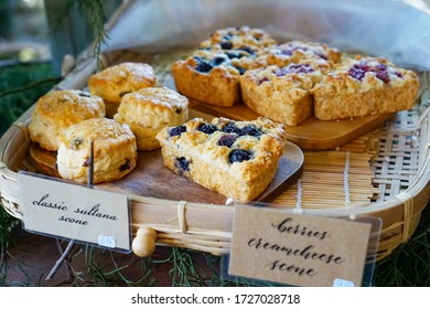 Berries Cream Cheese Scone And Classic Sultana Scone Put On Bamboo Basket In The Garden. It Has Ingredient Is Flour Dried Berry Eggs Sugar And Fresh Milk.