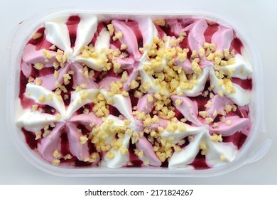 Berry Cream Dessert Ice Cream In A Plastic Box On A White Background, View From Above