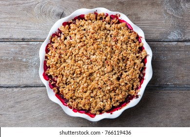 Berry Crumble, Crisp In Baking Dish. Wooden Background. Top View.