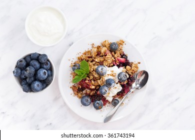 Berry Crumble With Oat Flakes On White Table, Top View, Horizontal