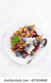 Berry Crumble With Oat Flakes On White Table, Vertical, Top View, Closeup