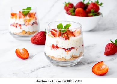 Berry dessert in glass with fresh strawberry, biscuit and whipped cream. Vegan lactose free dessert with alternative milk of coconut. Recipe of healthy organic dessert, cheesecake or berry trifle cake - Shutterstock ID 2088457198