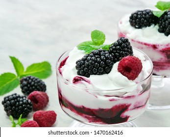 Berry Fruit Fool Dessert In Glass Bowl. Sweetened And Pureed Blackberries Folded Into Whipped Cream Topped With Whole Blackberries And Raspberries.