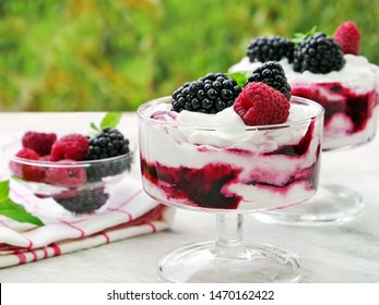 Berry Fruit Fool Dessert In Glass Bowl. Sweetened And Pureed Blackberries Folded Into Whipped Cream Topped With Whole Blackberries And Raspberries.