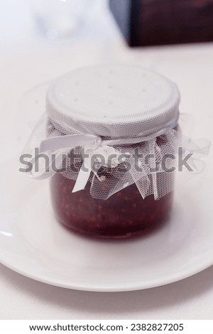 Berry jam in a decorated jar