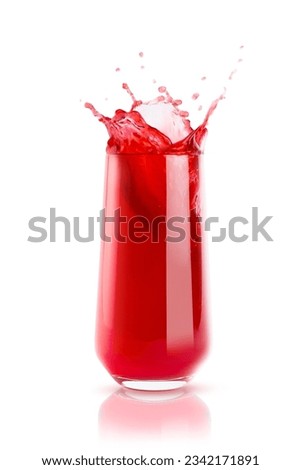 Berry red fresh juice in glass with reflection, bright colorful splashes, flying drops and swirl isolated on white background. Summer refreshing sweet vegetarian beverage.