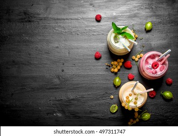 Berry smoothies with different berries. On the black chalkboard. - Powered by Shutterstock