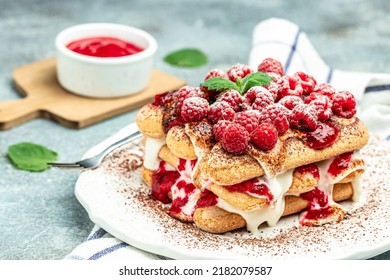 Berry Tiramisu With Biscuit With Coffee Cream And Fresh Berries. Tiramisu With Raspberry On A Light Background.