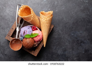Berry, vanilla and chocolate ice cream sundae. Top view flat lay with copy space