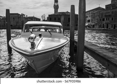 berthed boat on canal in Venice in a sunny day. (black and white version) 