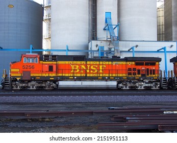 Berthold North Dakota - March 15 2022: A BNSF train stopped at a large grain silo in North Dakota