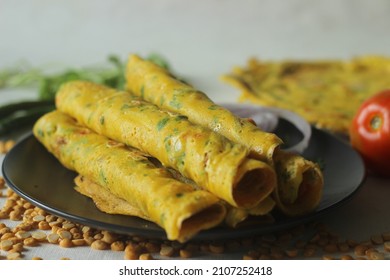Besan chilla or chickpea pancakes. These are protein rich savoury pancakes made of besan flour or chick pea flour with onions, tomato, green chili and coriander leaves . Shot on white backdrop
