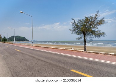 Beside Beach Road In Cloudy Day With Mountain Background.