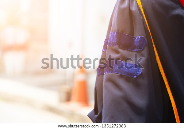 Beside Graduate\'s dress with left arm :\
Graduate\'s dress with master degree \
academic standing. Graduation\
ceremony. Success\
concept.