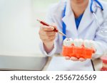 A bespectacled male doctor sits at a desk explaining about tooth decay, its causes such as plaque sugar, the process of demineralization,solutions for problems such as cracked,missing,  broken teeth