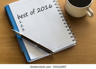 Best Of 2016 List - Handwriting On Notebook With Cup Of Tea And Pen.