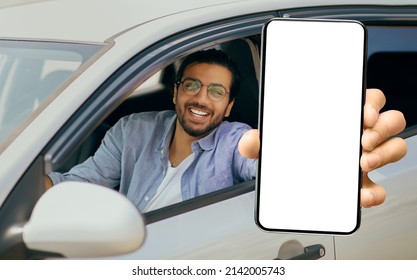 Best App. Happy Young Indian Man Showing Big Blank Smartphone At Camera While Sitting In Car, Handsome Male Demonstrating Mobile Phone With Place For Mockup, Recommending New Application, Collage