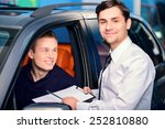 Best car rental. Handsome young car rental manager giving a copy space documents on clipboard to smiling client sitting a new luxury car 